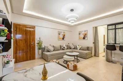 a living room with a couch and a table at Beautiful apartment in residence with pool in Marrakech