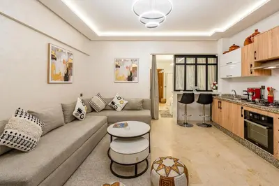 a living room with a couch and a table at Beautiful apartment in residence with pool in Marrakech