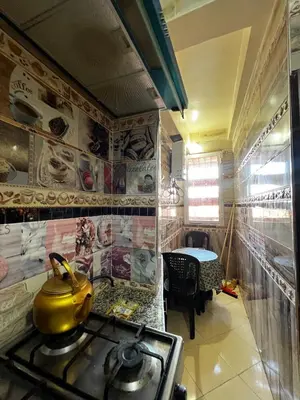 a kitchen with a yellow tea kettle on a stove at Apartment in Bassatine targa in Marrakech