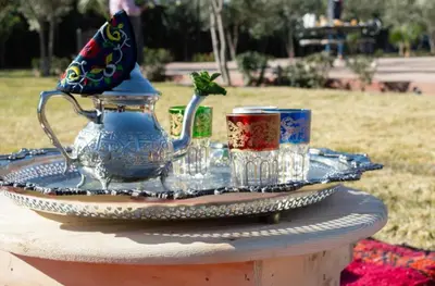 a table with a tea pot and cups on it at Villa Dar Saada in Marrakech