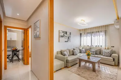 a living room with a couch and a table at Appartement familial 2 ch Wi-Fi 15 min centre in Marrakech