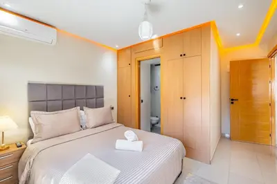 a bedroom with a bed with a white box on it at Appartement familial 2 ch Wi-Fi 15 min centre in Marrakech