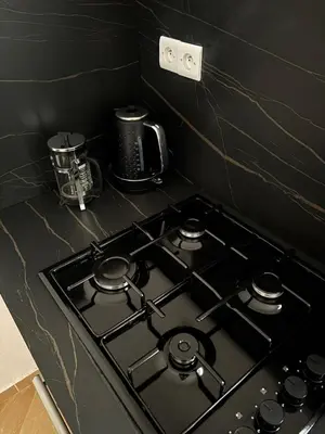 a black stove top oven in a kitchen at Appartement spacieux tout confort in Marrakech