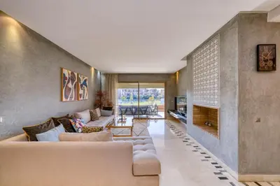 a living room with a couch and a fireplace at Family Apartment 3 Bedrooms Prestigia with Pool in Marrakech