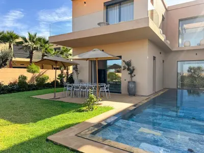 a villa with a swimming pool and a house at 4-Suite Villa, Private Pool at Jade Garden in El Rhechat