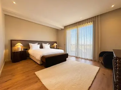 a bedroom with a large bed and a large window at 4-Suite Villa, Private Pool at Jade Garden in El Rhechat
