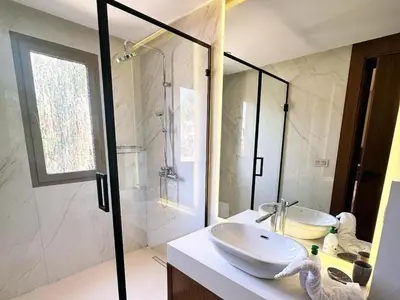 a bathroom with a white sink and a shower at Villa du Lac 4 suites in Prestigia in Marrakech