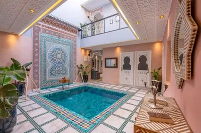 a large swimming pool in a room with a tile floor at Riad Dar Al Ghali in Marrakech