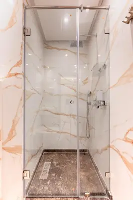 a shower with a glass door in a bathroom at Cocon Balnéo de Gueliz - Central & Balcon in Marrakech