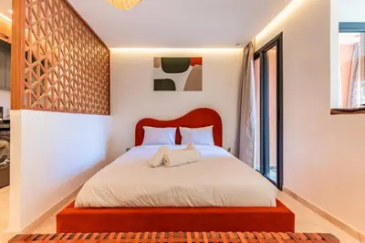a bedroom with a large bed with white sheets at Cocon Balnéo de Gueliz - Central & Balcon in Marrakech