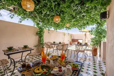 a table with food and drinks on a patio at Riad Nowara And Spa in Marrakech