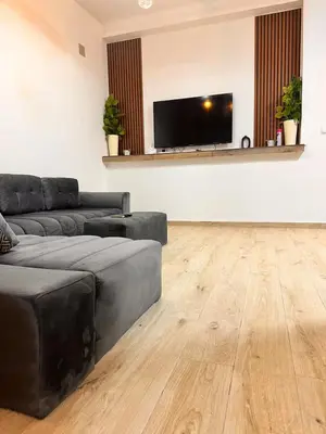 a living room with a couch and a flat screen tv at Studio Mhamid 10 in Marrakech