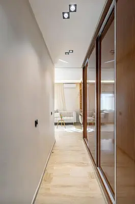 a hallway leading to a living room with glass doors at Apartment in the heart of Marrakech - 2BR in Marrakech