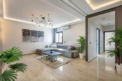 a living room with a couch and a table at Apartment in the heart of Marrakech - 2BR in Marrakech
