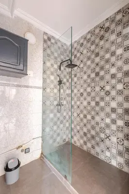 a bathroom with a shower with a glass door at Zou Appartement in Marrakech