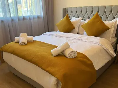 a bedroom with a bed with towels on it at Apartment with swimming pool full air-conditioned in Marrakech