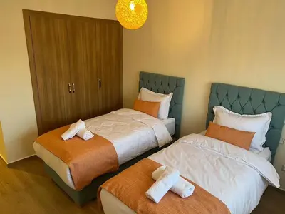 two beds in a hotel room with two crosses on them at Apartment with swimming pool full air-conditioned in Marrakech