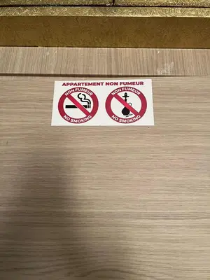 a sign on the door of an open door with a no parking sign at Apartment with swimming pool full air-conditioned in Marrakech