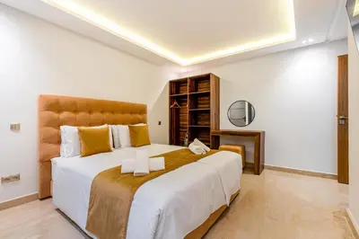 a bedroom with a large bed in a room at Sublime Villa in Agdal Elevator with heated pool in Marrakech
