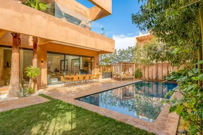 a swimming pool in the backyard of a house at Sublime Villa in Agdal Elevator with heated pool in Marrakech