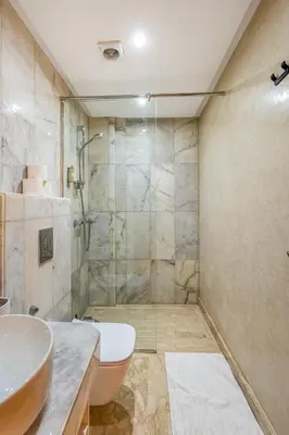 a bathroom with a shower and a toilet and a sink at Sublime Villa in Agdal Elevator with heated pool in Marrakech