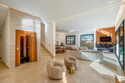 a living room with a couch and a dining room at Sublime Villa in Agdal Elevator with heated pool in Marrakech
