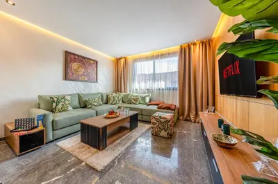 a living room with a couch and a table at Le Grand Jazzy in Marrakech