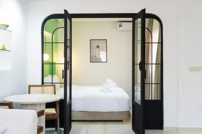 a bedroom with a bed and a table at Le Parisien Modern Studio in Hivernage in Marrakech