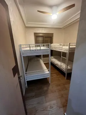 a hallway with bunk beds in a room at L'Oasis Des Amis in Marrakech