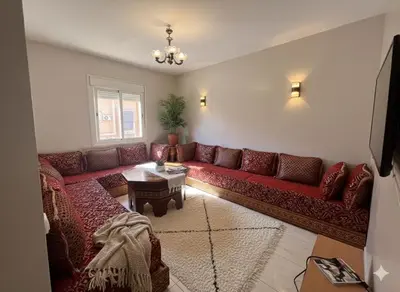 a living room with a red couch and a table at RS 13 by KMREI Properties in Marrakech