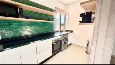 a kitchen with a sink and a washing machine at Fabuleux T4 110 m2 prestigia Luxury in Marrakech