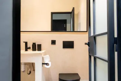 a bathroom with a sink and a mirror at Majorelle Modern A Unique Green Cocoon in Marrakech