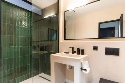 a bathroom with a sink and a shower at Majorelle Modern A Unique Green Cocoon in Marrakech