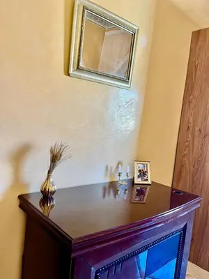 a table with a mirror on a wall at Spacieux Appart 2 chambres 6 Pers 12min Aéroport in Marrakech
