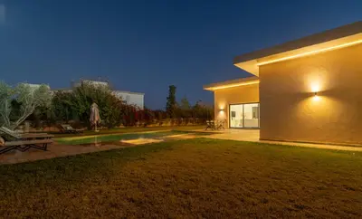a house with a lawn in front of a building at Domaine des lumières in Segraga