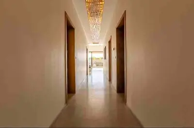 a hallway with white walls and a chandelier at Beautiful Villa Agathe with heated pool in Marrakech