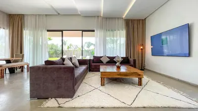 a living room with a couch and a coffee table at Syrine Villa with temperate pool, not overlooked in Marrakech