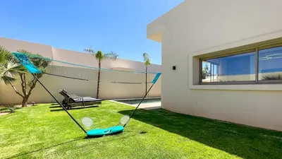 a swing in a yard in front of a house at Beautiful Stella villa with heated pool, Marrakech in Marrakech