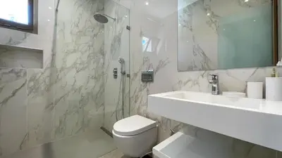 a white bathroom with a toilet and a sink at Beautiful Stella villa with heated pool, Marrakech in Marrakech