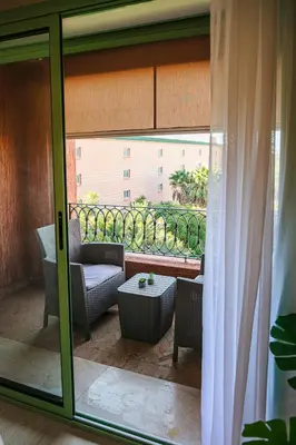 a room with a patio with a couch and a table at The Good Mood - Hivernage Marrakech in Marrakech