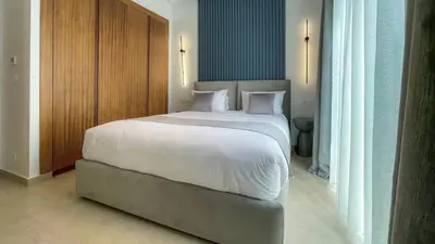 a bedroom with a large bed with white sheets at Beautiful Bianca villa with heated pool in Marrakech