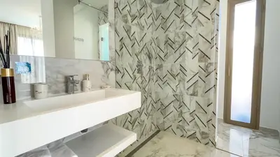 a white bathroom with a sink and a mirror at Superbe Villa Alma piscine chauffée à Marrakech in Marrakech