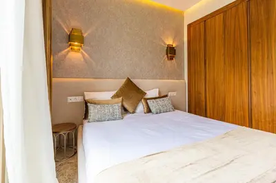 a bedroom with a white bed and two lights on the wall at Jade Villa with pool in Marrakesh in Marrakech