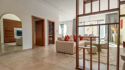 a living room with a couch and a mirror at Villa Amélia pool without opposite in Marrakech