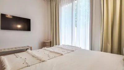 a white bed in a bedroom with a window at Beautiful Bahia villa with heated pool in Marrakesh in Marrakech