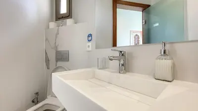 a white bathroom with a sink and a mirror at Beautiful Bahia villa with heated pool in Marrakesh in Marrakech