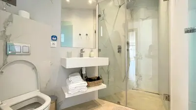 a bathroom with a toilet and a sink and a shower at Beautiful Bahia villa with heated pool in Marrakesh in Marrakech