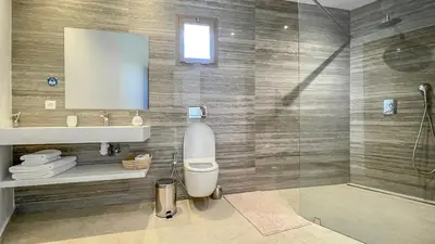 a bathroom with a toilet and a shower and a mirror at Beautiful Bahia villa with heated pool in Marrakesh in Marrakech