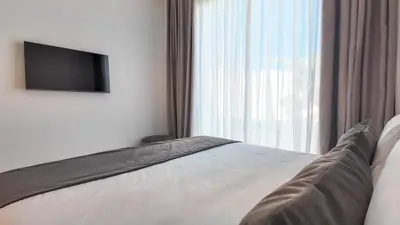 a bedroom with a bed with a television on the wall at Villa DALIA in Marrakech