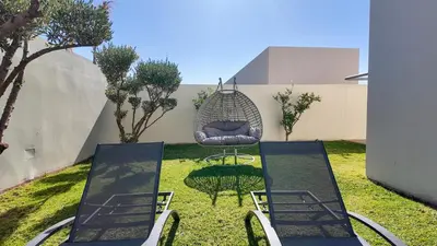 a patio with two chairs and a swing at Villa DALIA in Marrakech